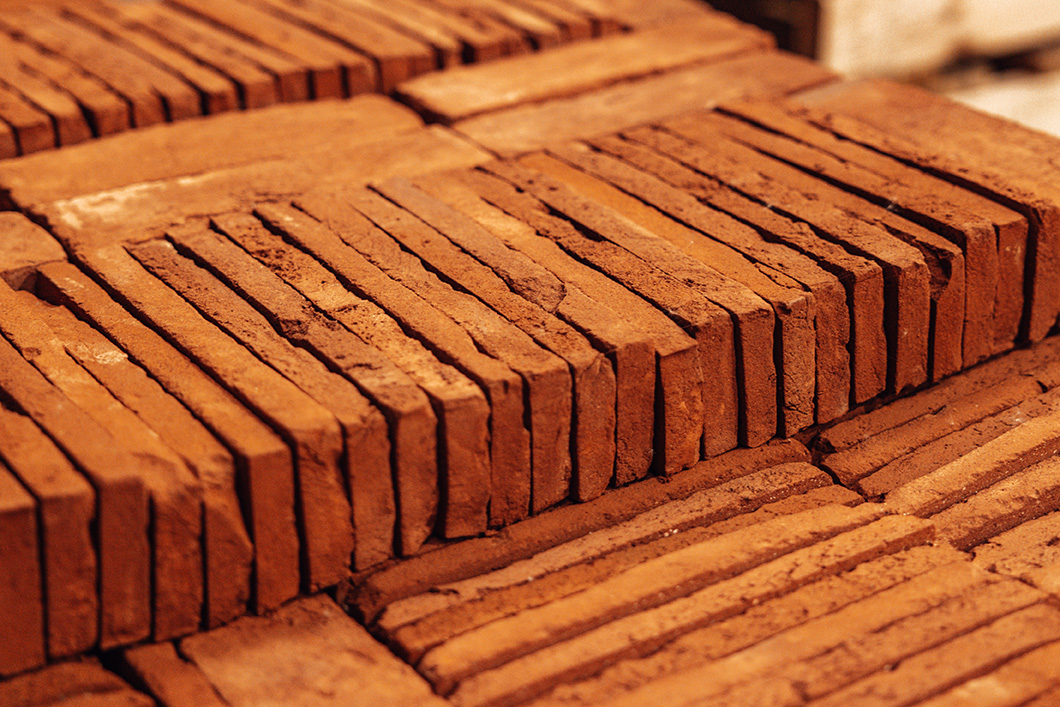 Close up view of red/orange colour brick slips on a pallet.