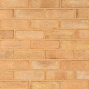 Blenheim Buff handmade brick slips shown in a wall. The bricks are a yellow buff tone with natural creases on the faces.
