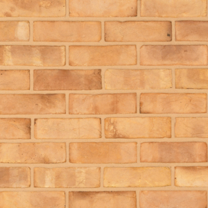Blenheim Buff Multi handmade brick slips shown in a wall. The bricks feature a blend of buff and pink tones.