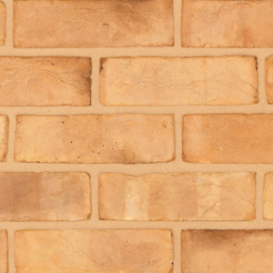 Blenheim Buff Multi handmade brick slips shown in a wall. The bricks feature a blend of buff and pink tones. Zoomed in to show the detail.