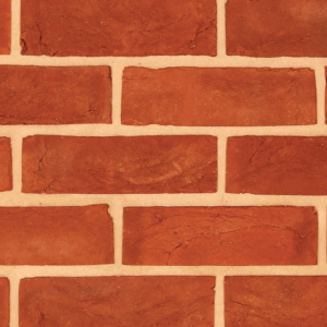 Hampton Red handmade brick slips shown in a wall. The bricks have subtle colour variations and soft creases on the faces. Zoomed in to show the detail.