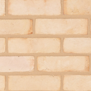 Kentwell White brick slips shown in a wall in detail. The brick slips are a chalky soft white with pink and cream undertones.