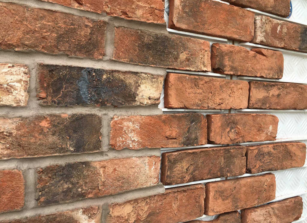 Example of an EWI (External Wall Insulation) brick slip system using handmade bricks.