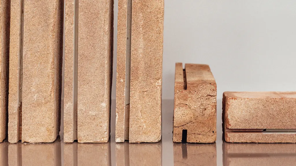 Close up of grooved brick slips, cut to order for use with a mechanical brick slip cladding system. Three slips are stood on-end, one laid in profile view and another lengthways to show all angles of the cuts.