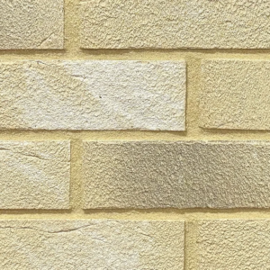 Yellow textured brick slips shown in a wall.