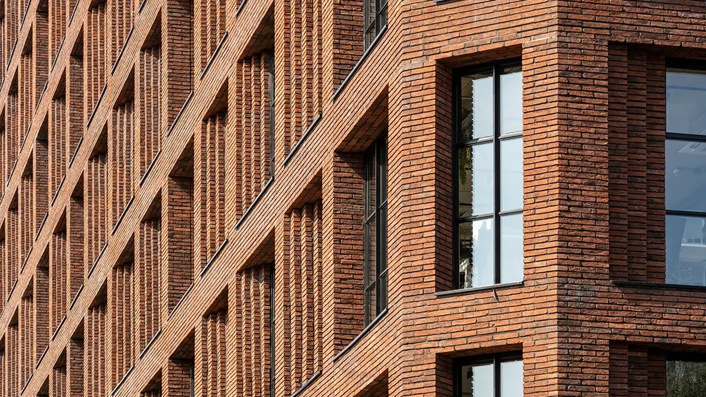 A large brick building complex with brick faced soffits overhangs.
